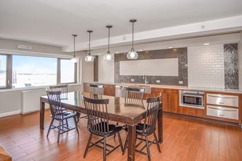 a club house with a table and chairs and a kitchen